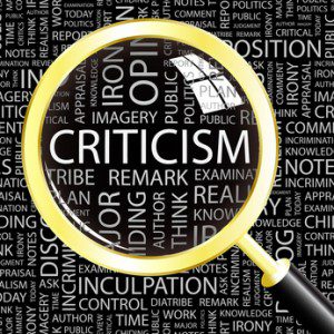 CRITICISM. Magnifying glass over different association terms.