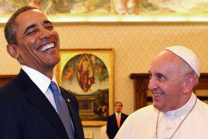 Pope Francis and U.S. President Obama react as they exchange gifts during a private audience at the Vatican City