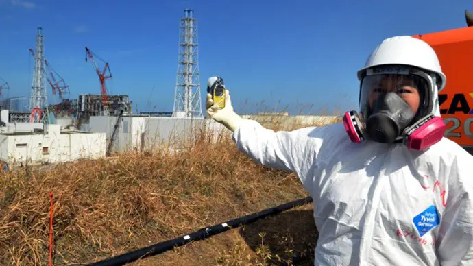 A Million Cancer Deaths from Fukushima Expected in Japan, New Report Reveals - Checking radiation levels with a dosimeter near the stricken Tokyo Electric Power Co Fukushima Daiichi plant